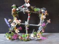 a small house made out of branches and flowers