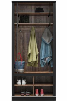 a coat rack with two coats, shoes and a tote bag hanging on it