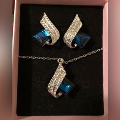 This Gorgeous & Unique Earrings & Necklace Set Features Blue Crystal Pendants With White Complementary Crystals On White Gold. These Are Nicely Lightweight To Not Pull On The Lobes At All. These Could Add The Perfect Finishing Touch To Any Dressy Outfit! Blue Costume Jewelry In Sterling Silver, Blue Sterling Silver Costume Jewelry, Blue Crystal Jewelry Sets For Gifts, Blue Crystal Jewelry Set For Anniversary, Sterling Silver Party Jewelry Sets With Matching Earrings, Party Sterling Silver Jewelry Sets With Matching Earrings, Sterling Silver Jewelry Set With Matching Earrings For Party, Blue Crystal Jewelry With Matching Earrings, Blue Sterling Silver Necklace With Matching Earrings