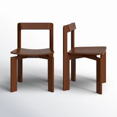 two wooden chairs sitting next to each other