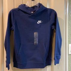 Boys Pullover Sweatshirt By Nike Brand, Size Medium. See Measurements For Specifics On Size! Pullover Hood, Brand Name In White Embroidery Hand Warming Pocket Long Banded Sleeves Ribbed Band Around Waistband Navy Blue Nike Sticker Body-80% Cotton/20% Polyester Hood Lining - 100% Cotton Rib - 97% Cotton/3% Spandex Machine Washable! Nwt! Navy Blue Nike Hoodie, Grey Nike Jacket, Nike Azul, Navy Blue Nike, Bday List, Tech Fleece Hoodie, Pink Crewneck Sweatshirt, Embroidery Hand, Nike Vintage