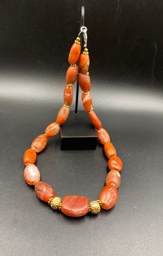 The Rare Unique PEMA RAKA Carnelian Amulet Prayer Beads Necklace From Himalayan Tibet The Age Of This Beads Are More than 1000 years Old As You Can See From Its Conditions Very Oily Smooth Skin Of This Pema Beads Some Gold Plated Wax and Gold Color Brass Beads Are Used As Spacers Rare Items For Collections Orange Beaded Amulet Jewelry, Orange Amulet-style Jewelry With Large Beads, Traditional Orange Jewelry For Healing, Traditional Orange Gemstone Jewelry, Traditional Orange Healing Jewelry, Traditional Agate Beaded Jewelry, Traditional Agate Gemstone Beads Jewelry, Orange Amulet Style Beaded Necklace With Polished Beads, Artisan Carnelian Beaded Necklace