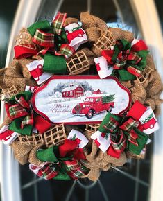 a christmas wreath with a red truck on it and burlocks around the wreath