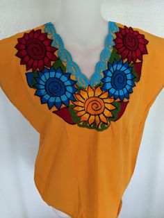 Brand New Chiapas Traditional One-Size-Fits-All Flowers Embroidered Tangerine Women's Blouse/ Shirt.  Traditional Women's Blouse from the Mexican State of Chiapas.  Beautiful to wear anytime or as a gift.  Tangerine color is like a light Orange coloer and it is beautiful.  Blouse is made of Cotton. Multicolor Floral Embroidered V-neck Top, Orange Embroidered Beach Top, Embroidered Orange V-neck Tops, Orange Embroidered Top For Beach, Orange Embroidered V-neck Top, Orange Bohemian Top With Floral Embroidery, Orange Cotton Blouse With Floral Embroidery, Orange Embroidered Cotton Blouse, Multicolor V-neck Top With Floral Embroidery