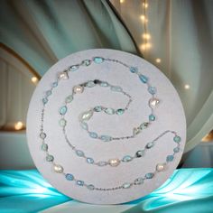 "Larimar is a special stone only found in the Dominican Republic in the Caribbean, this necklace is really unique. The combination of Larimar and freshwater pearls creates a sophisticated look. Necklace Length: 34\" length. Bracelet or choker Length: 15.25\" to 16.25\" Long -The necklace can be worn as a double-strand.  The bracelet can be worn as a short choker necklace. -Larimar nuggets; Cultured freshwater pearl: 6-7MM and 9-11MM  -Sterling silver clasp/non-tarnish silver-tone wire. https://www.etsy.com/shop/MYGEMSROCK" Larimar Necklace, Tarnished Silver, Pearls Necklace, The Dominican Republic, White Necklace, Necklace Blue, Freshwater Cultured Pearls, Colourful Necklace, Short Necklace