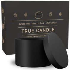 the candle tins are black and have gold lettering on them, along with an empty box