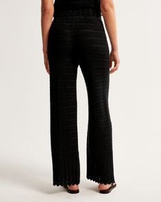 High rise pants in a soft sweater-knit fabric, that's unlined but not sheer, with elevated crochet-style stitching details throughout and an elasticated waistband for comfort and adjustability. Fitted Pointelle Knit Bottoms For Spring, Stretch Open Knit Pants, Chic Spring Pointelle Knit Bottoms, Fitted Knit Bottoms For Spring, Elegant Knit Bottoms For Spring, Casual Black Knit Bottoms, Black Knit Bottoms For Spring, Spring Pointelle Knit Bottoms, Spring Fitted Knit Pants