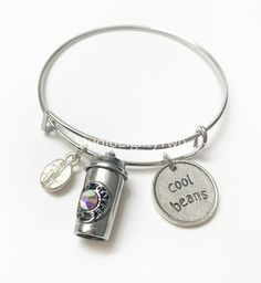 Bracelet features a Starbucks inspired coffee cup charm A silver coffee bean Silver round charm that says cool beans Personalized Silver Casual Jewelry, Personalized Casual Silver Jewelry, Casual Personalized Silver Jewelry, Casual Silver Metal Charm Bracelet, Casual Silver Charm Bracelet As Gift, Personalized Silver Charm Bracelet, Personalized Silver Charm Bracelet Casual Style, Casual Silver Charms Jewelry, Casual Personalized Silver Charm Bracelet