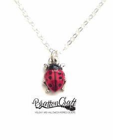 "Everyone is in love with this Hand Painted Red Ladybug Necklace! This is a TierraCast® original charm design. The charm is made in the USA using lead-free Britannia pewter with a nickel compliant fine silver double plating. The charm is approximately 1/2 inches long and 3/8 inches wide. Kimberly hand painted the ladybugs using a nontoxic epoxy resin made with organic compounds. The 16 inch chain shown is sterling silver, 1.5mm, flat cable style, finished with a lobster claw clasp and made in th Nickel-free Red Themed Jewelry, Nickel-free Themed Red Jewelry, Themed Red Nickel-free Jewelry, Adjustable Red Personalized Necklace, Cute Red Charm Necklace For Gift, Cute Red Charm Necklaces For Gifts, Cute Handmade Red Charm Necklaces, Cute Handmade Red Charm Necklace, Cute Red Handmade Charm Necklace