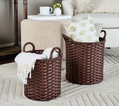 two brown wicker baskets sitting on top of a rug