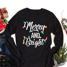 Classic Fit Festive Christmas Long Sleeve Shirts for Women - Merry and Bright, Cute Holiday Gift, Unisex Xmas T-Shirt. 8 Oz./Yd² (Us) 13.3 Oz./L Yd (CA), 50/50 Preshrunk Cotton/Polyester Heather Sport Colors: 60/40 Polyester/Cotton Safety Green: Compliant With ANSI / ISEA 107 Air Jet Yarn for Softer Feel and Reduced Pilling Double-needle stitching at Shoulders, Armholes, Neck, Waistband, and Cuffs 1x1 Rib With Spandex for Enhanced Stretch and Recovery Merry and Bright Christmas Shirt Grey Pearlized Tear Away Label Christmas Long Sleeve T-Shirt, Merry and Bright Unisex Long Sleeve Shirt, Christmas Holiday Shirt, Xmas Festive Gift Shirt. High-Quality Air Jet Yarn for Softer Feel and Reduced Pilling. Double-Needle Stitching at Shoulders, Armholes, Neck, Waistband, and Cuffs. Crafted with care Gift Black Long Sleeve Shirt, Black Long Sleeve Shirt Gift, Black Long Sleeve Holiday Shirt, Festive Long Sleeve T-shirt For Holiday, Black Long Sleeve Christmas T-shirt, Festive Long Sleeve Holiday T-shirt, Festive Long Sleeve Christmas T-shirt, Festive Long Sleeve Cotton T-shirt, Black Long Sleeve Christmas Shirt