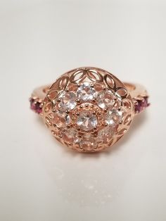 "Thanks for shopping our vintage estate store. We tend to sell well below wholesale and truly hope you enjoy all of our items. Many of the items are one of a kind, so please enjoy scrolling through the pictures and hopefully something will catch your eye. Brown spots are from the camera. Nice rose gold over sterling silver 925 natural 1ct morganite pink with rhodolite garnets cocktail ring. Ring size: please select ring size Setting: 5/8\" 15mm Band width: 2.3mm Weight: 4.81 grams Sweet ring, one that you will love. These came from an estate jewelry store that was closing. Marked 925." Vintage Rose Gold Rings With Accent Stones, Anniversary Multi-stone Topaz Ring, Vintage Rose Gold Jewelry With Halo Setting, Formal Cluster Ring Stamped 925, Hallmarked Rose Gold Round Ruby Ring, Antique Rose Gold Ruby Ring, Antique Rose Gold Round Ruby Ring, Rose Gold Rings Stamped 925 For Anniversary, Rose Gold Stamped 925 Rings For Anniversary