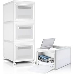 three white drawers with one open and the other closed in front of an empty file cabinet