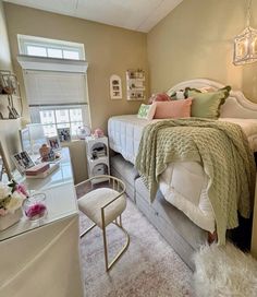 a bedroom with a bed, desk and chair next to a window in the corner