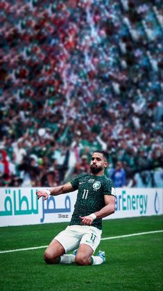 a man sitting on top of a soccer field