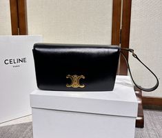 Color: Black. Shiny Calfskin leather. Lambskin-lining. Gold finished hardware.  Triomphe snap-button closure. Hand and shoulder carry. Inside flat pocket. Inside central zipped pocket. 2 internal compartments. Detachable leather strap.(Drops: 25 cm). Size: 24.5 × 14.5 × 3 cm. Celine box, dust bag and booklets included. Celine Trapeze, Celine Box, Fashion Gallery, Snap Button, Gold Finish, Calf Skin, Trendy Fashion, Leather Straps, Zip Pockets