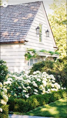 a house with white flowers in front of it