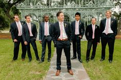 a group of men in suits standing next to each other