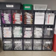 several plastic bins filled with different types of screwdrivers and other items on the floor