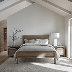 a bedroom with white walls and wooden furniture