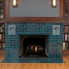 a fireplace in a library with books on the shelves