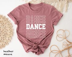 "Dance T-shirt Hi! Welcome to my store, I'm delighted to see you here. My store's main goal is to provide you with premium everyday apparel with the best graphic t-shirts.  DESCRIPTION * Printed and shipped from the USA. * We use state of art printing on soft and quality shirts. * Different size options; crewneck, youth, women's v-neck, toddler, and baby size options.  * Effective customer service and expedited shipping.  * Solid colors are 100% airlume combed and ringspun cotton.  * Heather colors 52/48 cotton/polyester. * Shoulder taping. Side-seamed. Fitted at bicep. Tear-away label. 4.2 oz. SIZES AND COLORS * Please refer to the size charts for measurements before placing an order. * You can compare our numbers to one of your favorite shirts to make sure. * Unisex shirts are true to si Relaxed Fit T-shirt For Dance With Short Sleeves, Cotton T-shirt With Letter Print For Dance Class, Summer Dance Class Crew Neck T-shirt, Relaxed Fit Crew Neck T-shirt For Dance, Casual Summer Dance T-shirt, Summer Crew Neck T-shirt For Dance Class, Summer Casual T-shirt For Dance, Casual Crew Neck T-shirt For Dance Class, Short Sleeve Graphic Tee For Dance Class