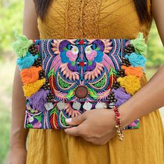 "This beautiful clutch bag is made with an amazing embroidered fabric made in the HMONG hill tribes of (Northern Thailand). It has a magnet opening and an inside zippered pocket. This bag is perfect to fit for ipad or phone, wallet, cosmetic etc. We buy materials from Hmong market and we design and sew by hand. Some of the bags we modify to improve the product. The Hmong tribes live in the North of Thailand ------------------------------------------ Size ----------------------------------------- Embroidered Multicolor Clutch Pouch, Multicolor Floral Embroidery Pouch Clutch, Embroidered Multicolor Pouch For Festival, Multicolor Embroidered Clutch For Festivals, Multicolor Floral Embroidered Clutch For Festivals, Bohemian Pouch Clutch With Multicolor Embroidery, Multicolor Embroidered Pouch For Festivals, Bohemian Multicolor Clutch Pouch, Bohemian Bags With Multicolor Intricate Embroidery