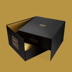 an open black box with gold foil on the inside that says,'mr & mrs '