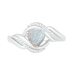 Make your romantic taste known with this charming heart ring. Crafted in sterling silver, this look showcases a 6.0mm heart-shaped iridescent lab-created opal cabochon. Diamond-accented and beaded ribbons surround the center in a bypass frame, while polished curved ribbons glisten along the shank to complete this cascading design. Buffed to a brilliant luster, this ring is certain to be enjoyed. Elegant Heart-shaped Opal Ring For Anniversary, White Heart Cut Ring With Birthstone, Ribbon Ring, Peoples Jewellers, Pretty Jewellery, Ring Sets, Heart Ring, Sterling Silver Rings, Heart Shapes