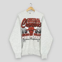 Vintage 90s Chicago Bulls NBA Sweatshirt Medium Chicago Bulls Central Division Champs Sweater Bulls American Basketball Gray Crewneck Size M Good Used Condition. No Stains and No Holes. Size (On Tag) : Size M **To make sure if it FITS YOU, refer at the exact measurements. Size Measurement (All measurements were taken lying flat) : Width [armpit to armpit] : 22.5 inches / 57 cm Length [shoulder to end of garment] : 28 inches / 71 cm THIS IS USED CLOTHING! PLEASE DON`T EXPECTED IT TO BE LIKE NEW O Throwback Long Sleeve T-shirt For Sports Events, Throwback Long Sleeve T-shirt For College, Throwback Long Sleeve Tops With Letter Print, Throwback Long Sleeve T-shirt For Streetwear, Throwback Long Sleeve Streetwear Top, Throwback Graphic Print Top For Winter, Throwback Long Sleeve Top With Graphic Print, Throwback Graphic Print T-shirt For Fall, Long Sleeve Basketball Sweatshirt For Sports Season