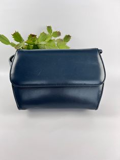 This  Simple Navy Blue Day Bag, a functional and stylish accessory for everyday use. This bag features a body of dark blue vinyl and a shoulder strap that makes it easy to carry. The spacious interior allows you to keep all your essentials organized and easily accessible. Measuring 8 1/2 inches by 6 1/2 inches, it is a perfect size for everyday use. The classic navy blue color and simple design make it a versatile option that can be paired with any outfit. In great condition for a vintage item. Classic Blue Shoulder Box Bag, Classic Blue Box Bag For Travel, Blue Satchel Bag For Business, Classic Blue Flap Bag For Everyday, Blue Business Satchel Bag, Classic Blue Shoulder Bag For Business, Classic Blue Rectangular Box Bag, Classic Blue Crossbody Flap Bag, Blue Modern Box Bag For Daily Use