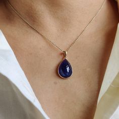 ITEM DESCRIPTION: >>The pendant is made from Solid 14K Yellow Gold. Gemstone used is absolutely natural and ethically sourced. >>Natural Tanzanite Cabochon in thick bezel setting is studded on it with utmost precision. >>This is a minimalist design and is absolutely hassle-free and everyday jewelry. Gem: Tanzanite Gem size: 13x18 mm & Pear Gem weight: 14.55 carats Gold purity: 14K (58.33% approx.) Gold weight: 0.65 grams Gross weight: 3.56 grams The Gold purity is guaranteed and it comes with au 14k Gold Teardrop Jewelry With Gemstone Accents, Elegant Yellow Gold Pear-shaped Gemstones, Elegant Pear-shaped Yellow Gold Gemstones, Luxury Tanzanite Pear-shaped Jewelry, Luxury Pear-shaped Tanzanite Jewelry, Elegant Gold Gemstones With Polished Finish, Elegant Drop Gemstone, Luxury Pear-shaped Gemstones For Gift, Formal Yellow Gold Tanzanite Jewelry