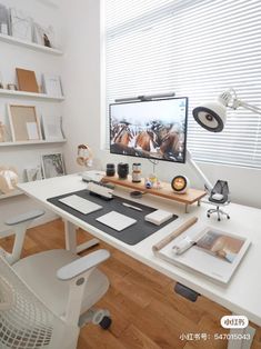 a white desk topped with a computer monitor