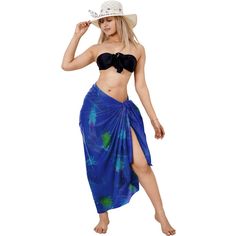 a woman in a blue skirt and hat posing for the camera with her hand on her hip