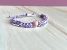 Lilac macrame bracelet with statement dyed Jade bead and sliding knot for adjustable fit Adjustable Pink Macrame Bracelets, Pink Adjustable Macrame Bracelets, Adjustable Pink Macrame Bracelet, Adjustable Pink Macrame Beaded Bracelets, Adjustable Pink Macrame Beaded Bracelet, Adjustable Purple Braided Bracelet With Sliding Knot, Casual Purple Bracelets With Sliding Knot, Adjustable Purple Braided Bracelet, Casual Adjustable Purple Braided Bracelets