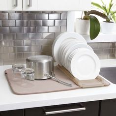 a kitchen counter with dishes and utensils on it