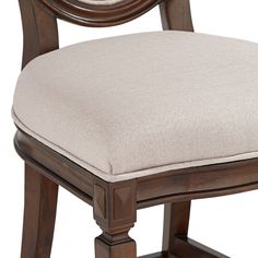 a close up of a wooden chair with a cushion on the seat and backrest