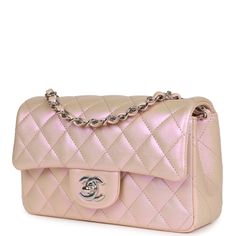 This Mini Rectangular flap bag is in pink iridescent calfskin with silver tone hardware and has a front flap with signature CC turnlock closure, rear half moon pocket and single interwoven pink leather and silver tone chain link shoulder/crossbody strap. The interior is lined in pink leather and features a zipper pocket with Chanel pull and an open pocket below.Collection: 21K (RFID)Origin: Italy Condition: New and never Accompanied by: Chanel box, Chanel dustbag, carebook, ribbon, felt and reta Chanel Metallic Bag, Chanel Mini Rectangular, Mha Dr, Chanel Box, Pink Iridescent, Aesthetic Edits, Chanel Mini, Pink Lady, Hermes Bags