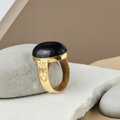 An impressive design with a chic vintage art-deco pattern! Crafted from 10k yellow gold, this stunning ring features one oval black onyx cabochon. Hats off to you and your impeccable taste! Metal: 10k yellow gold Stone: natural black onyx Stone size: 1.5 x 2.0 cm (0.6" x 0.8") Shape: oval cabochon Setting type: bezel Formal Black Dome Ring With Polished Finish, Elegant Black Dome Ring With Polished Finish, Classic Engraved Cabochon Ring, Black Cabochon Signet Ring For Formal Occasions, Formal Black Cabochon Signet Ring, Formal Black Oval Cabochon Signet Ring, Luxury Oval Signet Ring With Black Enamel, Luxury Oval Black Enamel Signet Ring, Art Deco Rings With Oval Cabochon Polished Finish