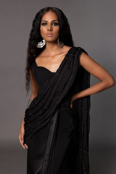 Black corset style saree featuring fitted bodice with placed stone embroidery and pleated waistline highlighted by crystal embellishments. Comes with stone and bead embroidered belt. - Aza Fashions Elegant Embellished Pre-draped Saree For Gala, Embellished Fitted Pre-draped Saree For Gala, Elegant Black Embellished Pre-draped Saree, Elegant Draped Sets With Sequins, Elegant Draped Sequin Sets, Pre-draped Embellished Evening Saree, Evening Embellished Pre-draped Saree, Embellished Pre-draped Evening Saree, Embellished Pre-draped Saree For Evening