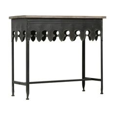 an iron and wood console table with holes in the top, on a white background