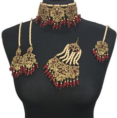 a necklace and earring set with red beads