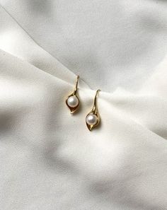 Very elegant classic earrings in the shape of leaf with white pearl inside. Metal is gold plated 925 silver. Natural pearls are AAA quality. Handmade in Spain. Comes in a gift box. Delicate White Gold-plated Pearl Earrings, Delicate White Gold Plated Pearl Earrings, Formal Pearl Drop Flower Earrings, Elegant Pearl Flower Earrings For Formal Occasions, Elegant Pearl Drop Flower Earrings For Formal Occasions, Elegant Pearl Drop Flower Earrings For Formal Events, Formal Pearl White Flower Earrings With Pearl Drop, Elegant Formal Flower Earrings With Pearl Drop, Elegant Pearl White Flower Earrings For Formal Occasions