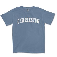 "Comfort Colors Charleston T Shirt Represent the one and only Holy City of Charleston, South Carolina with these custom Comfort Colors T-Shirts. Designed with a collegiate font in the classic arc and printed in white, they are sure to stand out in a crowd while at the beach, walking down King Street, hanging at the Spoletto Festival, or checking out the college of Charleston. Want to rep another city or state but don't see it listed in our gallery listed in our gallery OR you want to share a special message? Just shoot us a message or check out our listing for personalized comfort colors t shirts. This customized comfort colors t shirt is designed with a collegiate font, so they are sure to stand out in a crowd and the perfect way to say something bold. You will receive a mockup image for Coastal Granddaughter Shirts, North Carolina Shirt, Collegiate Font, Beach Walking, College Of Charleston, Preppy Shirt, Beach T Shirts, Beach Shirt, Comfort Color