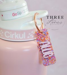 Due to high order volume during peak times, shipments may be delayed up to 3 business days.Cue the Confetti! Introducing our NEW water bottle name charm, the ideal tag for personalization! Boost your Tumbler experience with these custom name tags designed for the Cirkul Water Bottle models perfect size for kids and adults. We absolutely adore personalization, and these darling accessory name plates are the perfect way to add a custom touch to your tumbler. Plus, they make fantastic gift ideas too!These will fit most water bottle handles.DETAILS:Made from durable acrylic with 3D name. We do not accept returns or refund if these don't fit your tumbler so double check size and version you have. Name Tag Design, Bottle Charms, Kids Water, Kids Water Bottle, Tag Design, Bottle Accessories, Name Tags, Name Tag, Fantastic Gifts