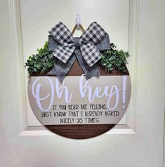 a wooden sign with a bow on it