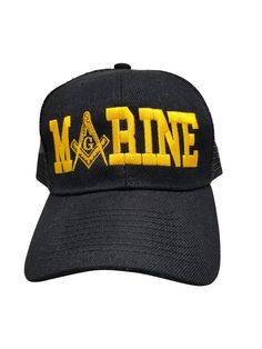 a black hat with yellow letters and masonic symbols on the front, embroidered onto it