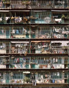 an apartment building with lots of cages on the top and bottom floors filled with birds