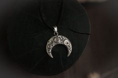 Lunula pendant with real moon texture. Price is listed per 1 item. Pendant without chain, the rubber cord in the set. Also, you can order this lunula pendant in a bronze:https://www.etsy.com/listing/745597208✪ MATERIALS: sterling silver, gemstone✪ DIMENSIONS: 1.18”/ 3 cm✪ CORD LENGTH: 13-15”/ 35-40 cm + extension chain✪ CUSTOM ORDER INFO: - Contact me personally for custom orders. - All the items are fully handmade and it takes some time to make them. Please visit for timing info: https://goo.gl Spiritual Moon Phase Pendant Jewelry, Healing Moon Phase Pendant Jewelry, Bohemian Crescent Jewelry Oxidized Finish, Bohemian Crescent Jewelry With Oxidized Finish, Hand Forged Spiritual Jewelry For Larp, Mystical Engraved Round Pendant Jewelry, Festival Moon Phase Round Pendant Jewelry, Spiritual Moon Charm Pendant Jewelry, Moon Shaped Sterling Silver Festival Jewelry