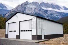 a large white building with mountains in the background